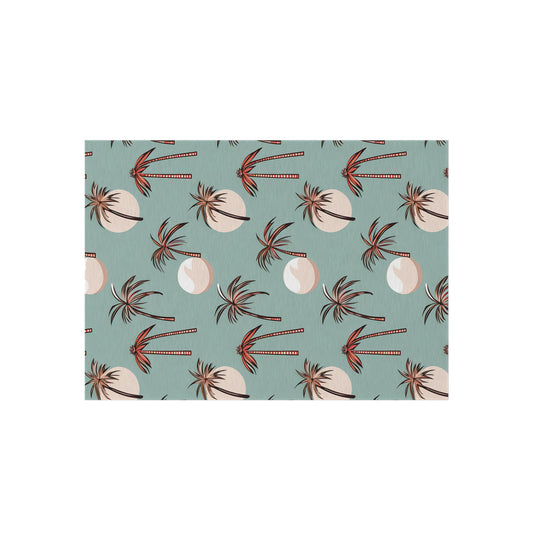 Summer Palm outdoor rug in seafoam green with coral palm trees, shown flat