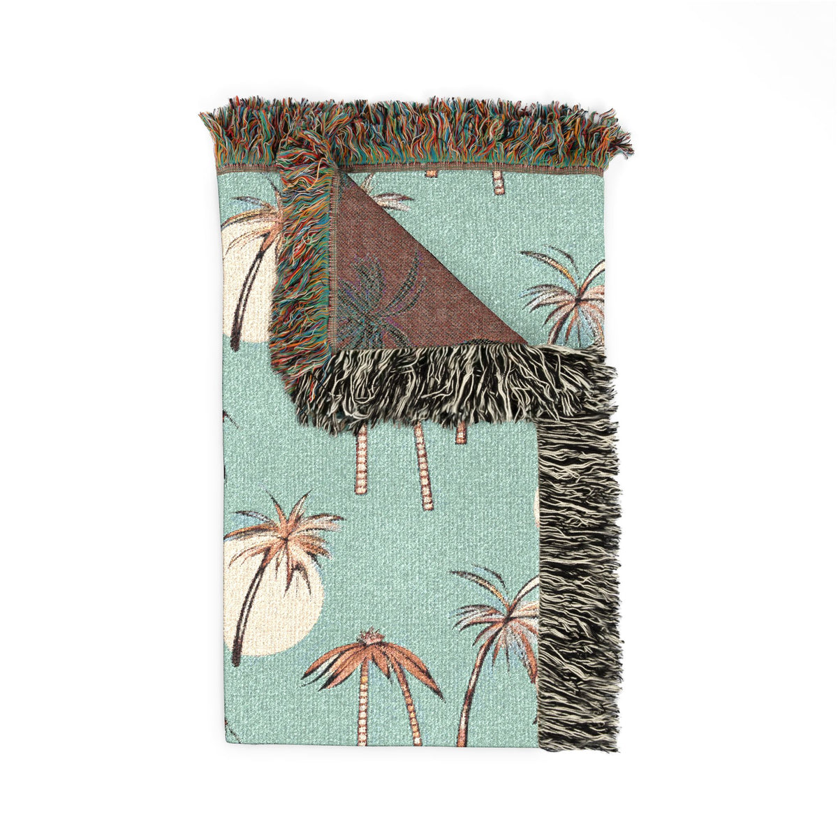 Folded Summer Palm woven blanket showing the palm print front and the rust reverse side