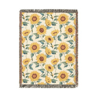 Sunflower woven blanket in cream with yellow sunflowers and green leaves, shown flat