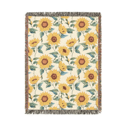 Sunflower woven blanket in cream with yellow sunflowers and green leaves, shown flat