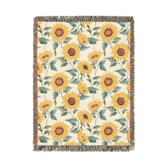 Sunflower woven blanket in cream with yellow sunflowers and green leaves, shown flat