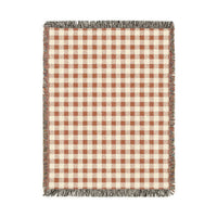 Terracotta gingham woven blanket with a rust and cream check pattern