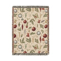 Vintage Christmas woven blanket with glass baubles, brass bells, holly and pine on cream