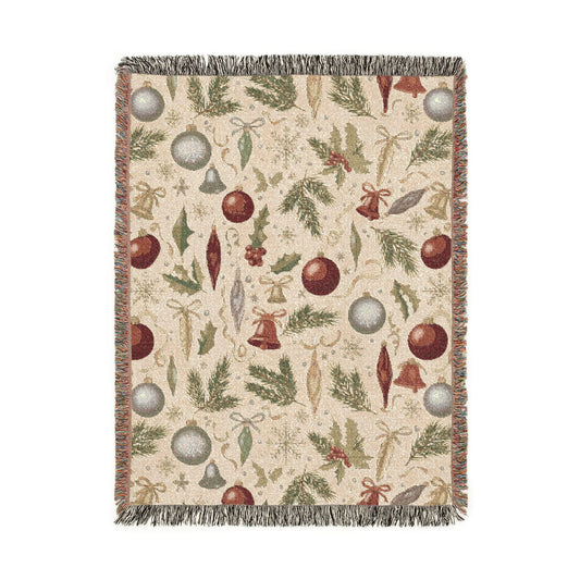 Vintage Christmas woven blanket with glass baubles, brass bells, holly and pine on cream