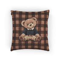 Vintage teddy bear woven pillow featuring a bear in a sweater on a buffalo plaid pattern