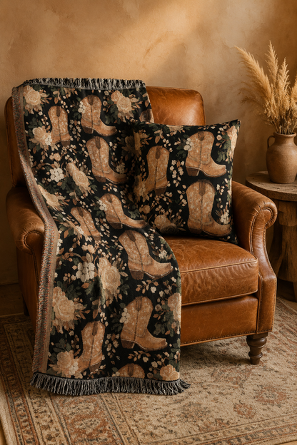 Western cowboy boots and roses set with the woven blanket and pillow on a leather armchair