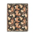 Western woven blanket with brown cowboy boots, peach roses and green leaves on black, shown flat