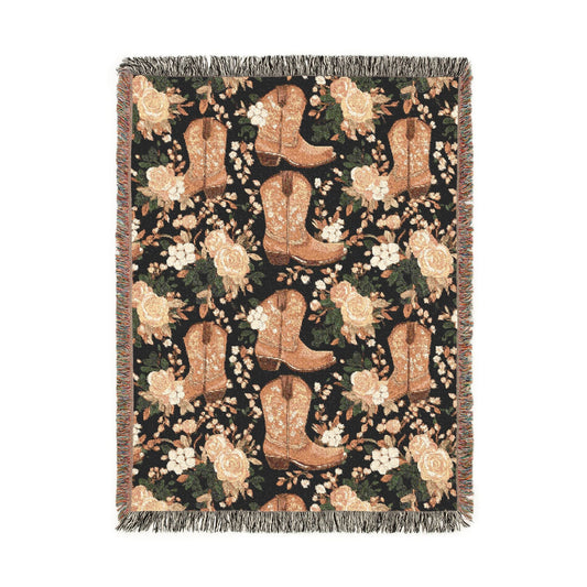 Western woven blanket with brown cowboy boots, peach roses and green leaves on black, shown flat