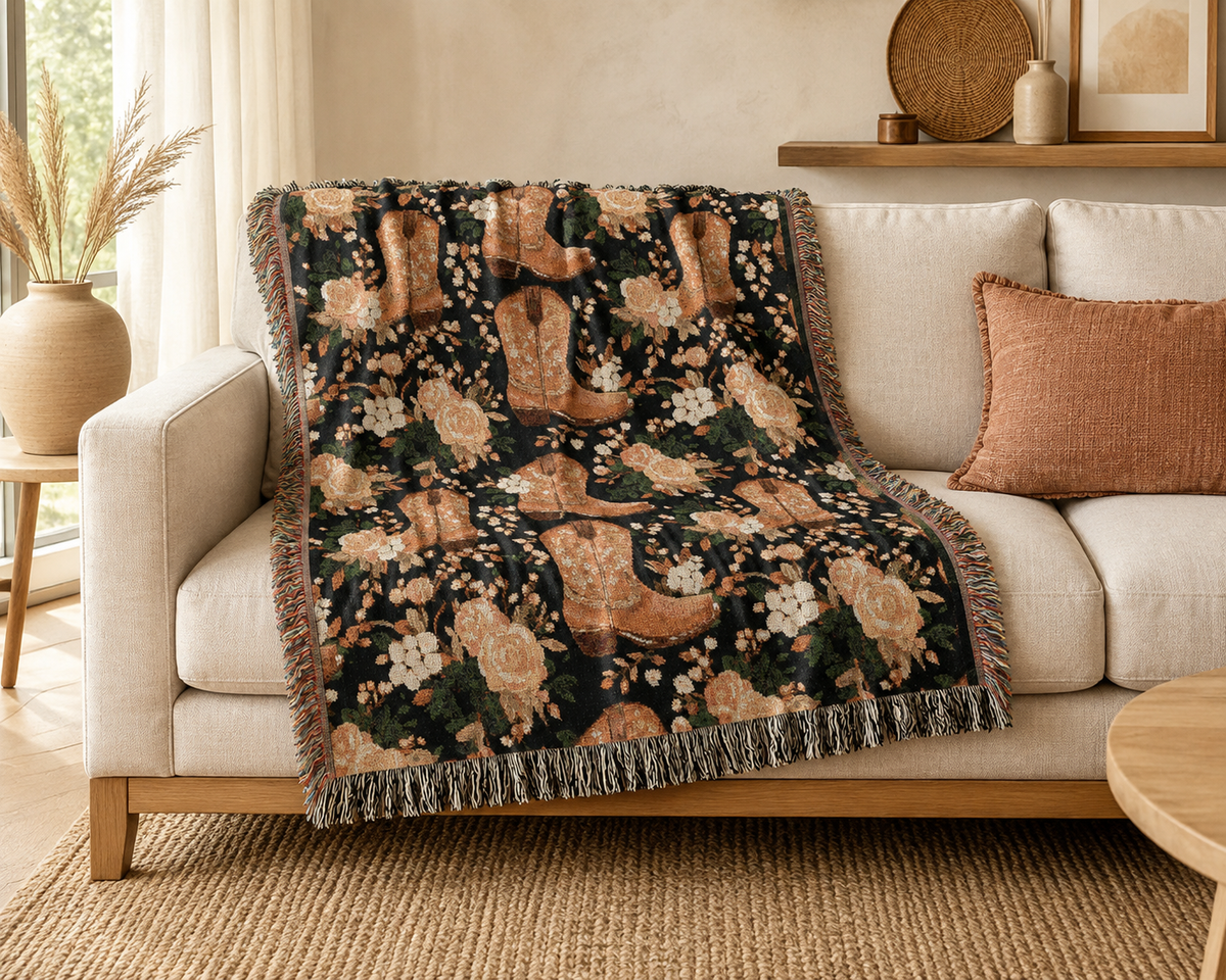 Western cowboy boots woven blanket draped over a cream sofa with rust and cream cushions