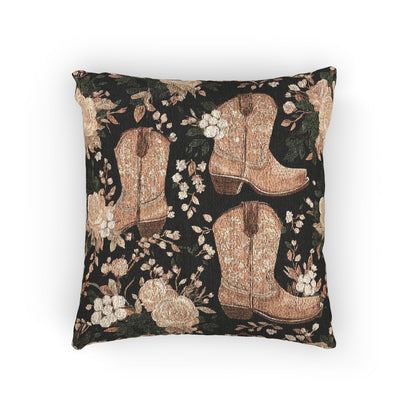 Woven pillow with tan cowboy boots, peach roses and cream blossoms on a black ground, front view