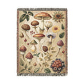 Wild Mushroom woven throw blanket with a botanical mycology print of mushrooms, leaves, berries and pinecones, front view