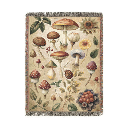 Wild Mushroom woven throw blanket with a botanical mycology print of mushrooms, leaves, berries and pinecones, front view