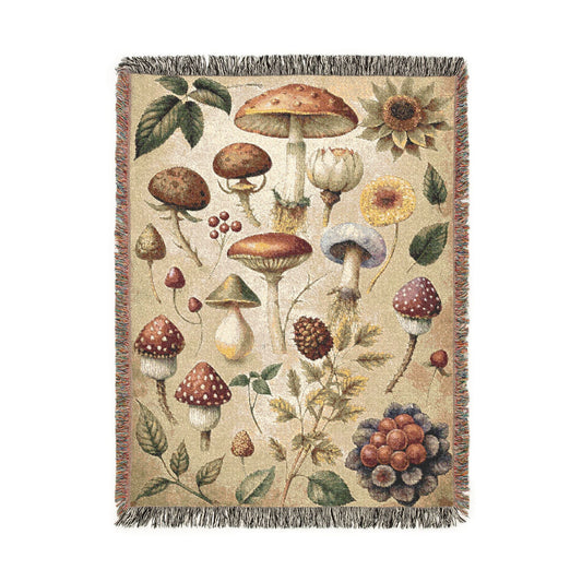 Wild Mushroom woven throw blanket with a botanical mycology print of mushrooms, leaves, berries and pinecones, front view