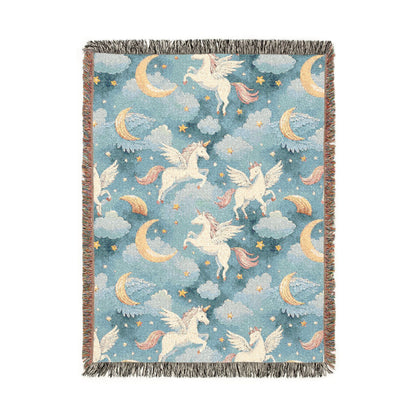 Woven blanket with cream winged unicorns, crescent moons, clouds and stars on a teal blue ground, shown flat
