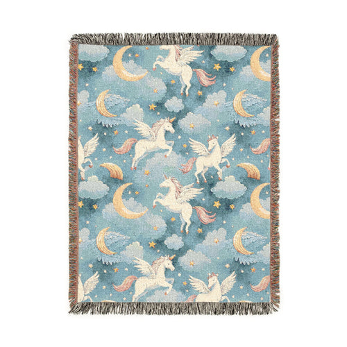 Woven blanket with cream winged unicorns, crescent moons, clouds and stars on a teal blue ground, shown flat
