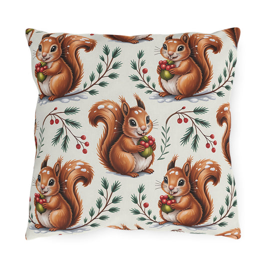 Winter Squirrel outdoor pillow with red squirrels and berry branches on cream, front view