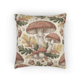 Woodland mushroom woven pillow featuring red-capped toadstools, golden oak leaves and acorns on a cream ground