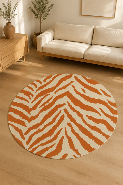Terracotta zebra round rug on a wooden floor in front of a cream sofa
