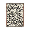 Zebra woven blanket in black and cream with a zebra stripe pattern, shown flat