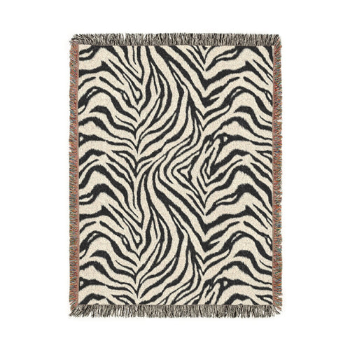 Zebra woven blanket in black and cream with a zebra stripe pattern, shown flat