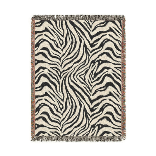 Zebra woven blanket in black and cream with a zebra stripe pattern, shown flat